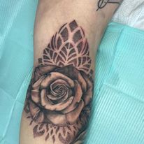 rose with dot filigree tattoo by bella at tantrix body art